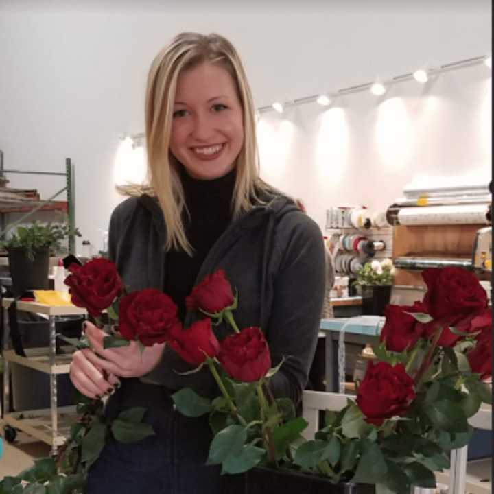 Christina Foley is a wedding planner at Flowers By Whisconier in Brookfield.  She is holding up the heart rose, which the shop is featuring this Valentine&#x27;s Day.