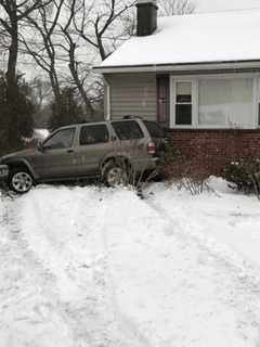 SUV Skids Off Icy Road, Strikes House In Hillcrest