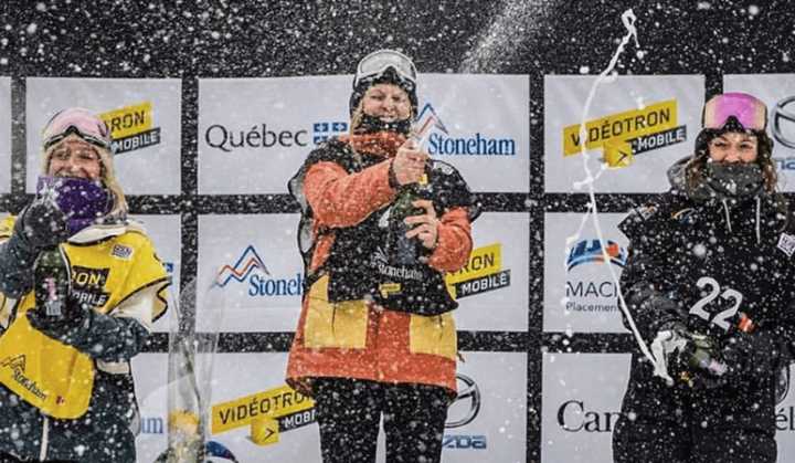 Julia Marino, center, of Westport pops the cork on another gold medal after winning a slopestyle snowboarding event Sunday in Canada.