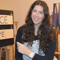 <p>Meagan Cann shows a lily bracelet, made from a bull&#x27;s horn and sisal grass in an artisan workshop in Rwanda.</p>