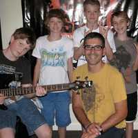 <p>David Morgan (front and center), owner and founder of the Music Shed in Redding, surrounded by his students</p>