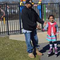 <p>7-year-old Ashlee Evans with her father Rodney Evans, enjoying the summer-like weather Friday afternoon at Rogers Park in Danbury</p>