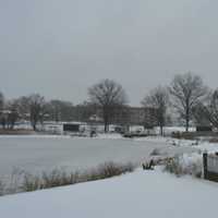 <p>Icy waters push up against the edge of Ellsworth Park in Bridgeport.</p>