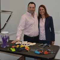 <p>Wet Paws owner Olivier Leibowitz and his wife, Tamara Peterson, stand at one of the grooming stations.</p>