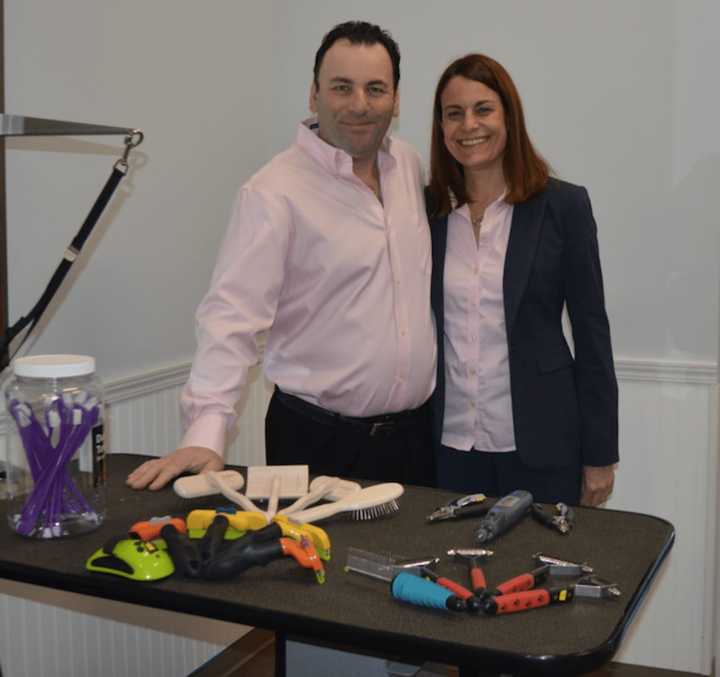 Wet Paws owner Olivier Leibowitz and his wife, Tamara Peterson, stand at one of the grooming stations.