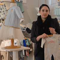 <p>Darcy Callahan, manager at Pink Lemon, Blue Lime in Westport, shows some of the store&#x27;s fashions.</p>