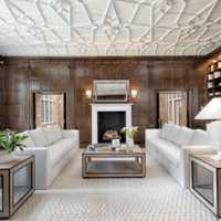 <p>The home has 11 fireplaces, including this one in the living room.</p>