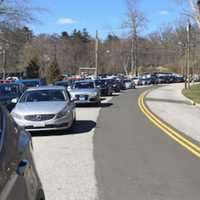 <p>Motorists double parked outside Greenwich High School as they wait for a lockdown to end. Police said they are investigating a noontime threat at the school.</p>