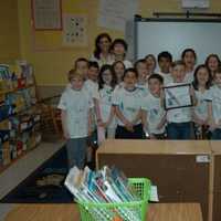 <p>Concord Road Elementary School in Ardsley, where second-grader Andrew Wenzel shows off his certificate with classmates.</p>