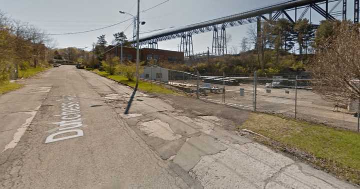 A person is trapped in a trench at the old Dutton Lumber site.