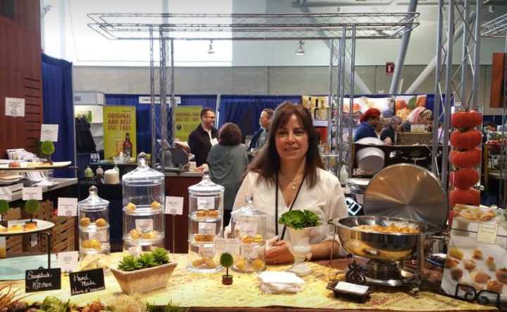 Co-owner Sonia Wells poses with some of Saugatuck Kitchens&#x27; delectable appetizers.