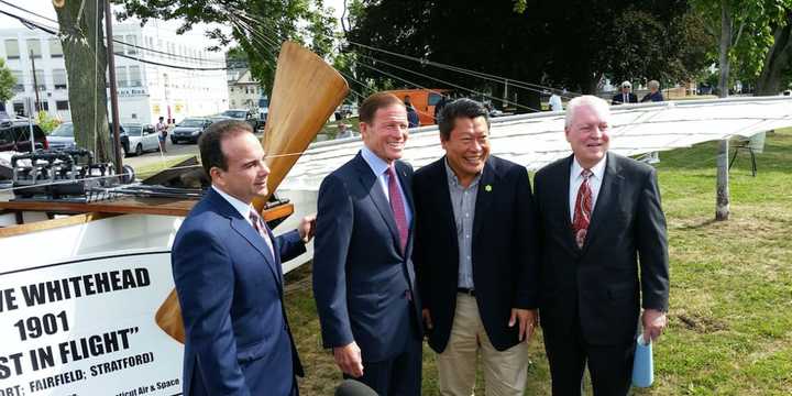 Bridgeport Mayor Joe Ganim, U.S. Sen. Richard Blumenthal,  state Sen. Tony Hwang and Fairfield First Selectman Mike Tetreau stand before a replica of Whitehead&#x27;s aircraft.