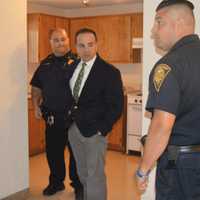 <p>Bridgeport Mayor Joe Ganim tours the new police post at  P.T. Barnum Apartments with Sgt. Frank Cuccaro, left, and Officer Michael Salemme, right.</p>