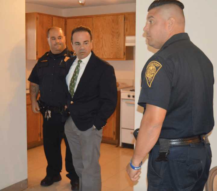 Bridgeport Mayor Joe Ganim tours the new police post at  P.T. Barnum Apartments with Sgt. Frank Cuccaro, left, and Officer Michael Salemme, right.