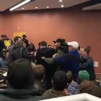 <p>A brawl breaks out at as Lucian Wintrich, White House correspondent for The Gateway Pundit, grabs a female student to retrieve a paper she took from his podium during a speech at UConn.</p>