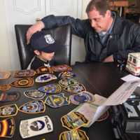 <p>Fair Lawn police officer Ian Manelis with Fort Lee&#x27;s Raphael.</p>