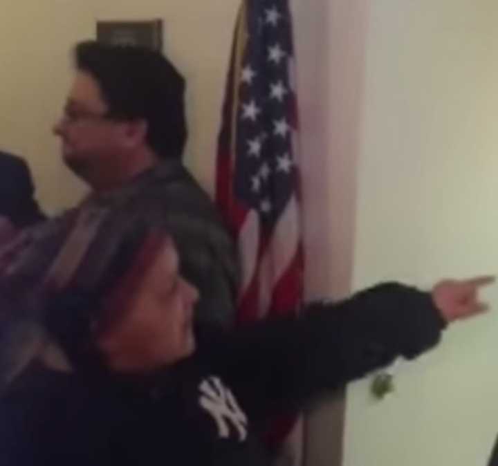 A woman shouted vulgarities before being arrested during an impromptu news conference by Gov. Andrew Cuomo.