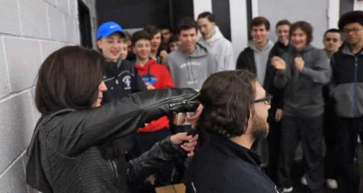 New Rochelle High School Coach Paul Viggiano donated his ponytail to Locks of Love to honor his mother who died of lung cancer.