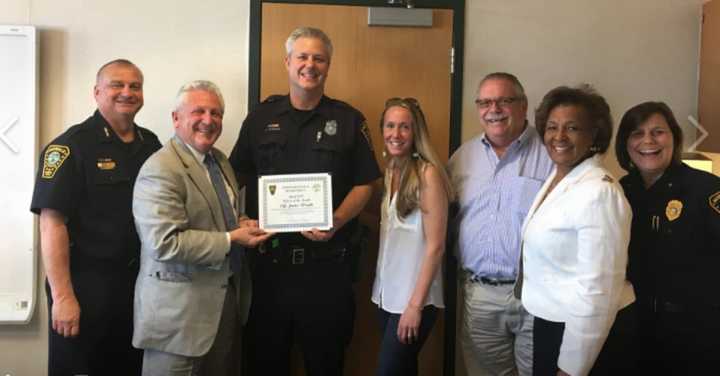 From left, Norwalk Police Chief Thomas Kulhawik, Mayor Harry Rilling, Officer Jamie Wright with his fiancee, Kelly, Commissioner Charlie Yost, Commissioner Fran Collier-Clemmon and Deputy Chief Susan Zecca.