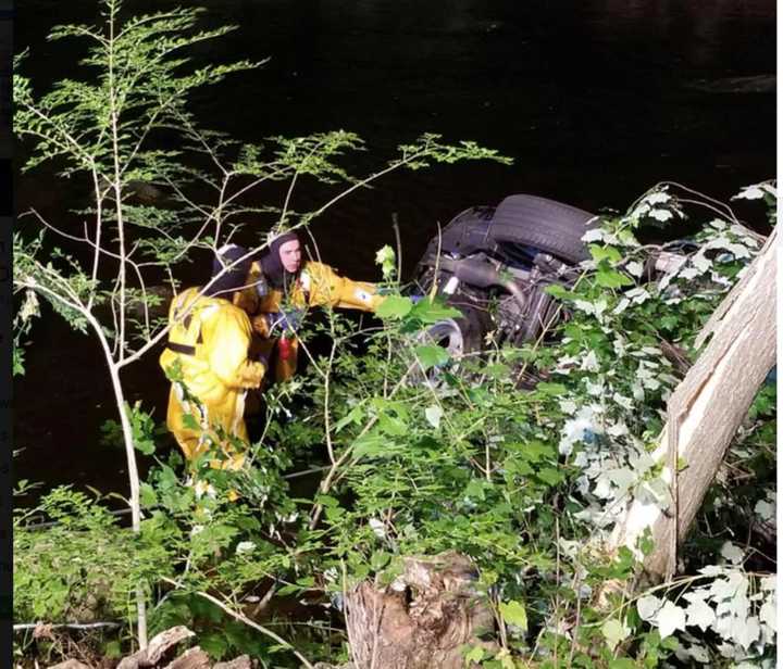 The SUV after it landed in the Saugatuck River on Sunday night.