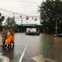 <p>Firefighters Joe Micalizzi and Kevin Campbell from Engine 5 assist &amp; remove several individuals from multiple vehicles at the intersection of Elm and South State Street.</p>