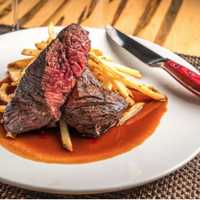 <p>Steak Frites from BWT: 10oz hanger steak, truffle parmesan fries, 72-hour red wine sauce</p>