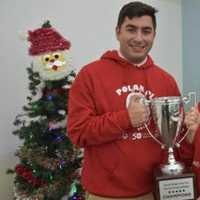 <p>Nicholas, a senior at Iona Preparatory, and Plungers moderator Patricia Gray with the Cool School Challenge trophy on December 17, 2018.</p>