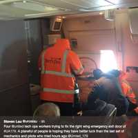 <p>Steven Lau tweeted this photo of airport workers trying to fix the door from inside of the plane.</p>