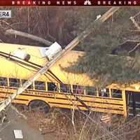 <p>Eight children and one adult were helped off of a bus that crashed into a Long Hill utility pole Monday, toppling live power lines.</p>