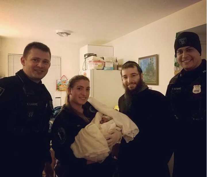 Police Sgt. Kyle Laauwe and Patrolman Saul Gutierrez helped deliver a baby girl on Tikvah Way at 12:22 a.m. Sunday.