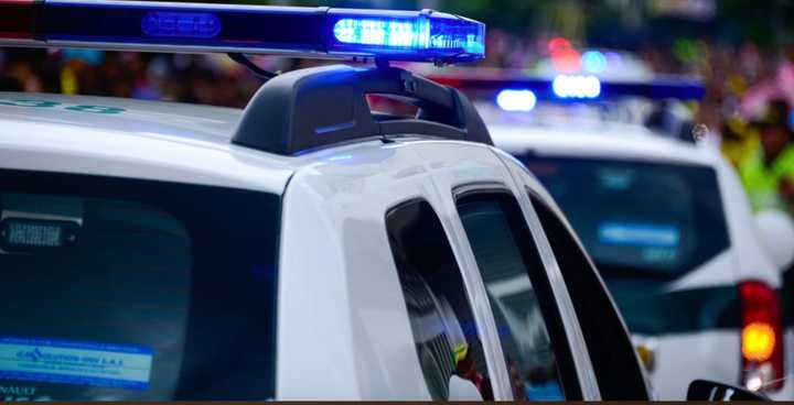 Three men, one wanted on a warrant for murder, were arrested following a chase and nabbed with guns and drugs.