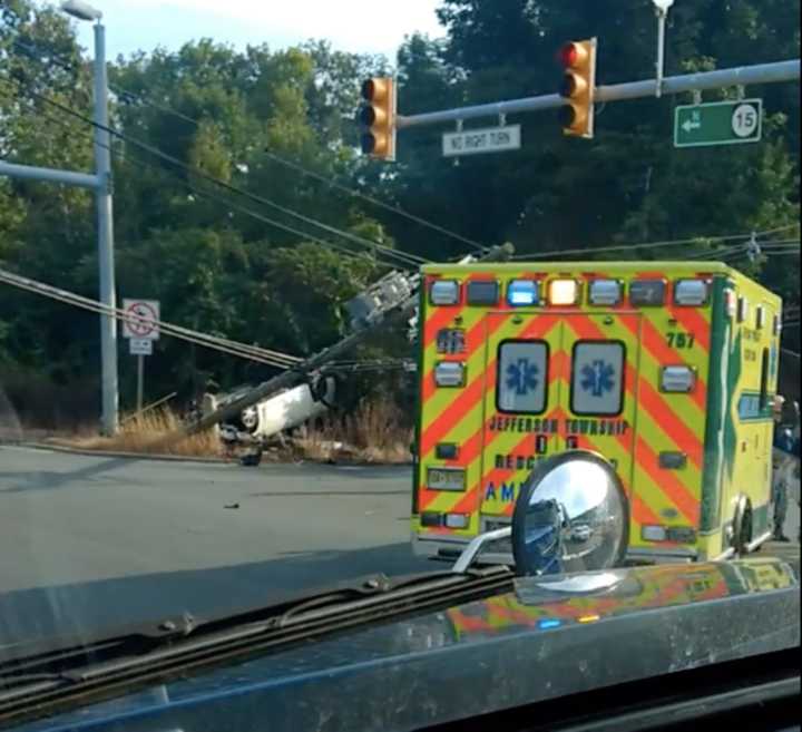 An overturned car knocked down a utility pole, closing Route 15 in Jefferson Thursday.