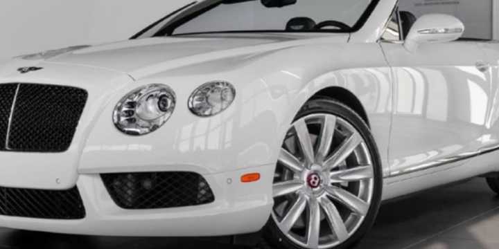 A man was arrested after attempting to purchase a Bentley at a Jericho dealership with a stolen identity.