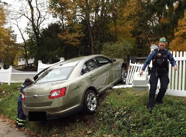 The car careened through a white-picket fence in Hawthorne.