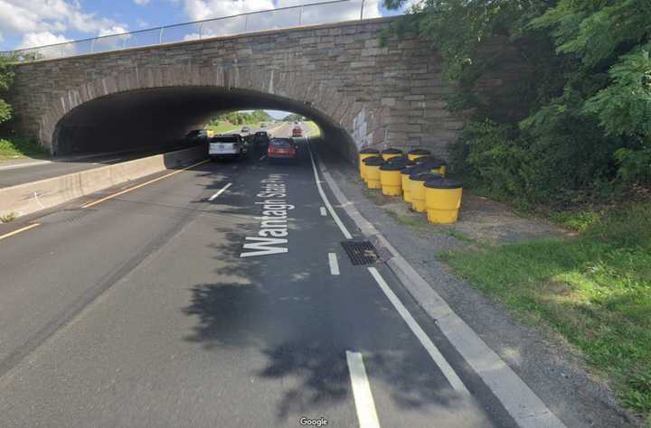 The Hempstead Turnpike overpass while driving southbound on the Wantagh State Parkway.