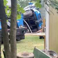 <p>Scene of a crane collapse in Tinton Falls, as captured on video by Jacques John Guire. The front wheels of the cab of the tipped-over crane can be seen in this image.</p>