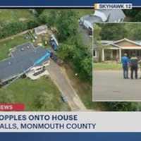 <p>An aerial view of Wednesday&#x27;s crane collapse in Tinton Falls by News12&#x27;s chopper. (The blue image is the mid-section of the 85-foot-crane atop the house roof.) A ground view is on the right.</p>