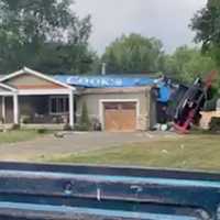 <p>An 85-foot crane atop the roof of a home in Tinton Falls.  (Screengrab from Facebook video posted by Jacques John Guire)</p>