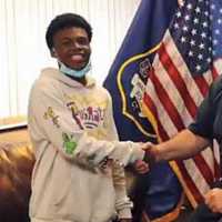 <p>Waterbury Police Chief Fernando Spagnolo shaking hands with Justin Gavin, 18.</p>