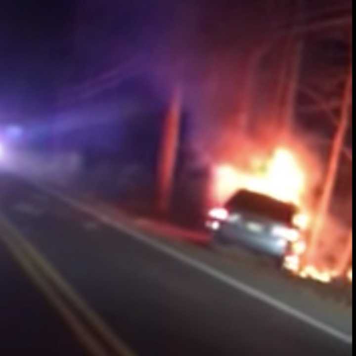 A Howell police officer rescued a driver from this fiery crash.