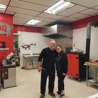 <p>Alicia and Desi Dutcher togther in the kitchen of Legal Swine BBQ</p>