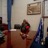 <p>Justin McAuliffe (right) inside a Senate or House office.</p>