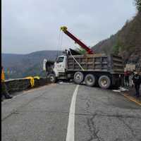 <p>A dump truck almost went over a mountain and into the river below after crashing into a rock retaining wall.</p>