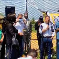 <p>Gov. Ned Lamont, Sen. Richard Blumenthal, and Mayor Joe Ganim speak with residents and parents at Newfield Park.</p>