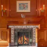 <p>There are multiple fireplaces throughout the residence, and a wood-paneled library.</p>