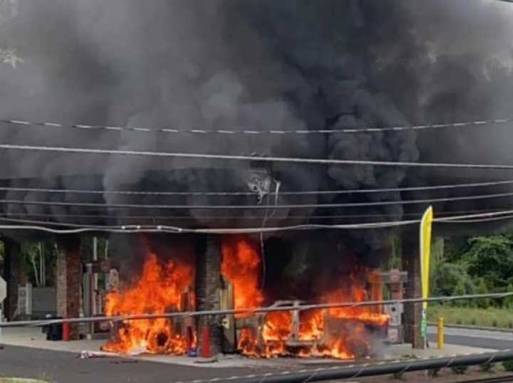 One person was hospitalized after a vehicle went up in flames that extended to a gas station on Route 206 Monday morning, authorities said.