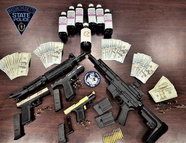 Massachusetts State Police seized weapons, drugs, and cash during a traffic stop.