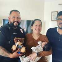 <p>Montclair Officer Ortiz with baby Diego and his parents,</p>