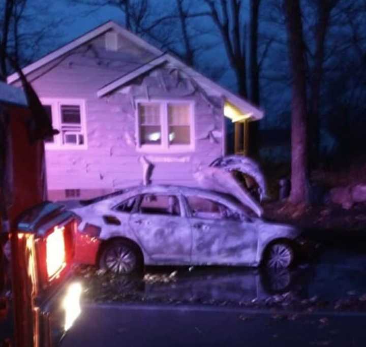 A Hopatcong car fire spread to a nearby patch of woods and melted the siding of a building before crews doused the blaze Wednesday night, authorities said.