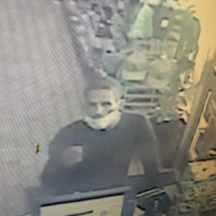 The wanted man using the stolen credit card in Amityville.